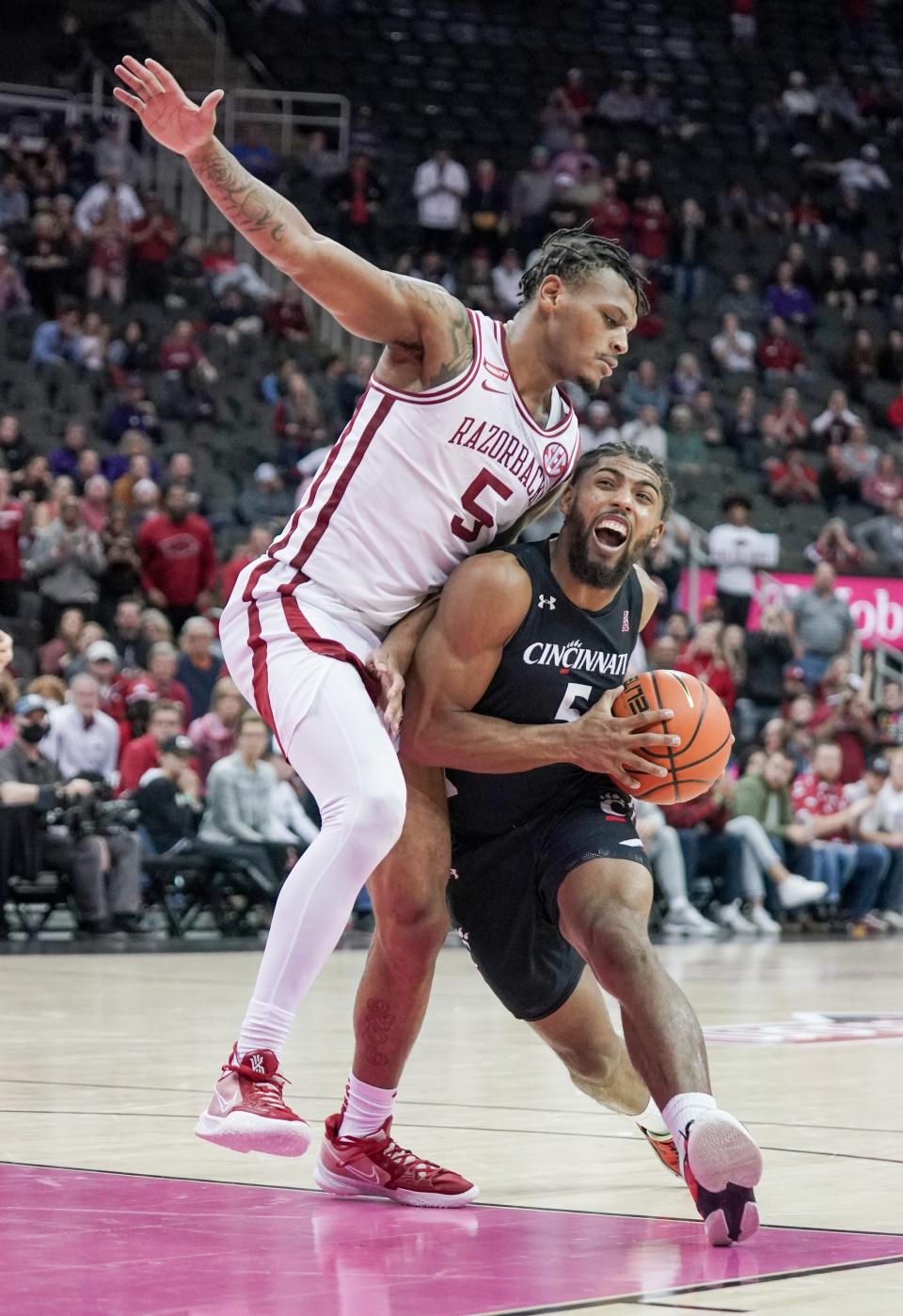 Nov 23, 2021; Kansas City, Missouri, USA; Cincinnati Bearcats guard David DeJulius (5) goes up for a shot as Arkansas Razorbacks guard Au'Diese Toney (5) defends during the second half at T-Mobile Center. Mandatory Credit: Denny Medley-USA TODAY Sports