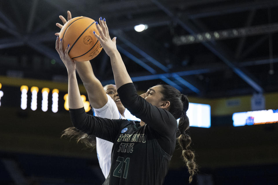 UCLA guard Charisma Osborne, back, blocks a shot by Sacramento State guard Kaylin Randhawa during the first half of a first-round college basketball game in the women's NCAA Tournament, Saturday, March 18, 2023, in Los Angeles. (AP Photo/Kyusung Gong)