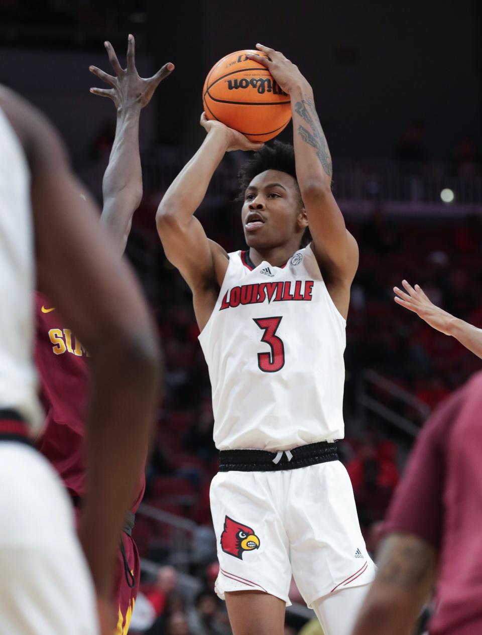 U of L's Koron Davis shoots against Simmons College defenders during an exhibition game Oct. 18 at the KFC Yum! Center.