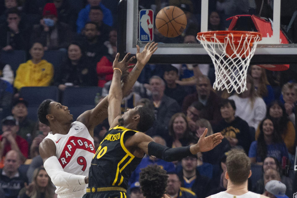 Toronto Raptors forward RJ Barrett (9) lays up a shot over Golden State Warriors forward Jonathan Kuminga (00) during the first quarter of an NBA basketball game, Sunday, Jan. 7, 2024, in San Francisco. (AP Photo/D. Ross Cameron)