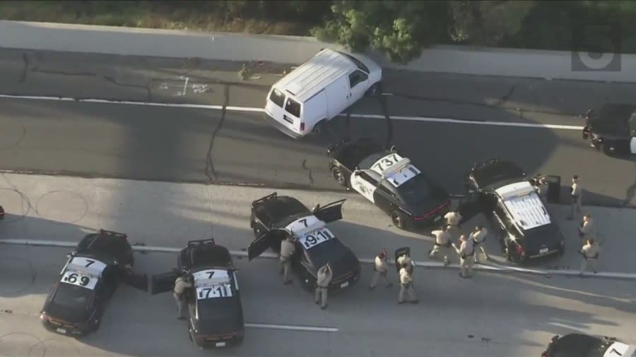 Officers surrounded the van after a successful second PIT maneuver on the 91 Freeway was successful. (KTLA)