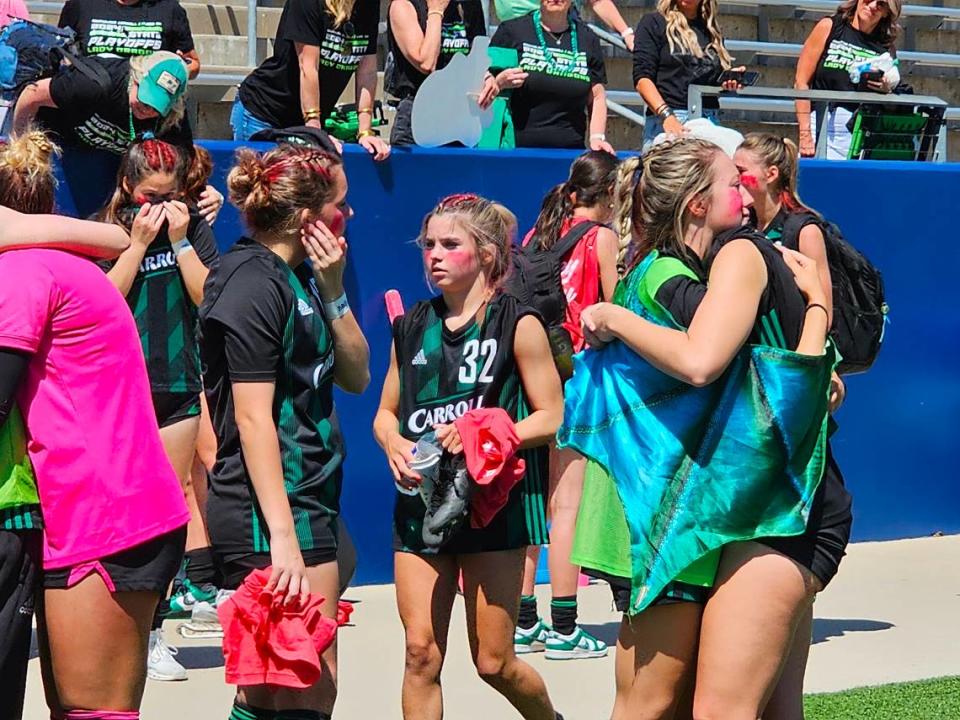 Southlake Carroll girls soccer players embrace following a regional semifinal loss to Prosper at McKinney ISD Stadium on April 5, 2024. Darren Lauber