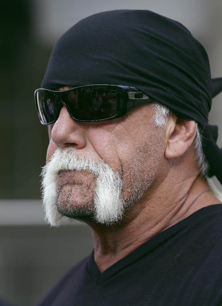 Reality TV star and former pro wrestler Hulk Hogan, whose real name is Terry Bollea, looks on as his attorney speaks during a news conference Monday, Oct. 15, 2012 at the United States Courthouse in Tampa, Fla. Hogan says he was secretly taped six years ago having sex with the ex-wife of DJ Bubba "The Love Sponge" Clem. Portions of the video of Hogan and Heather Clem were posted on the online gossip site Gawker. (AP Photo/Chris O'Meara)