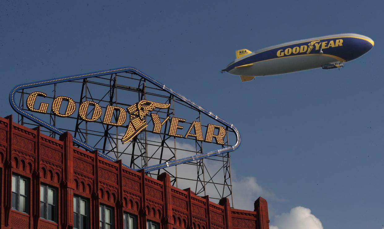 The Goodyear blimp flies past the newly relit Goodyear  sign during The Well CDC's Imagine the Future celebration in Akron. The famous sign has been dark since 2015.