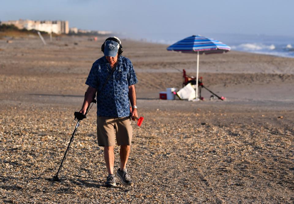 Surfers, beach walkers, sightseers and treasure hunters with metal detectors were out on the beaches Saturday morning. Just north of the Westgate Cocoa Beach Pier, Roger Bellz of  Virginia was out looking for treasures in the sand.