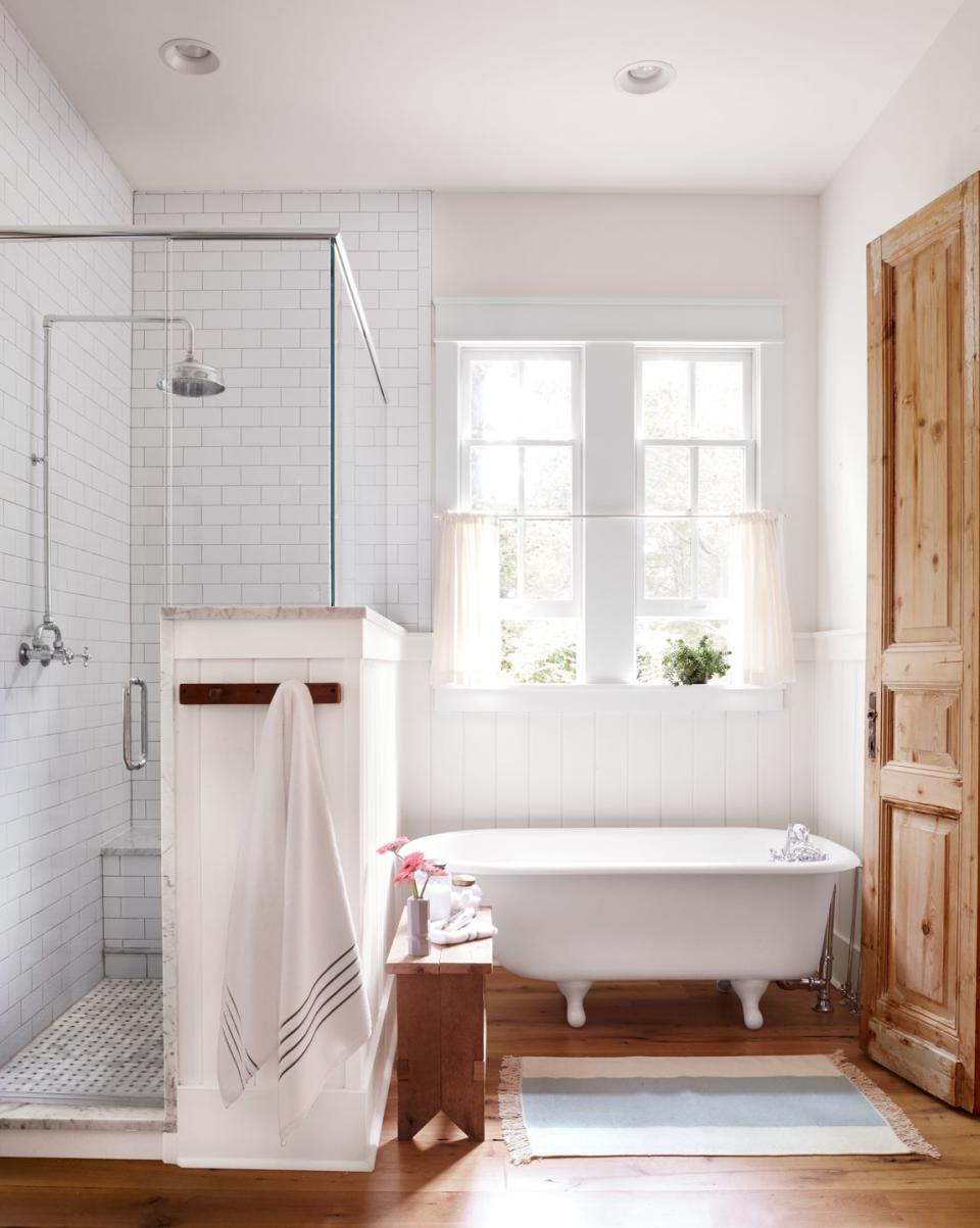 a bathroom with a tub and a window