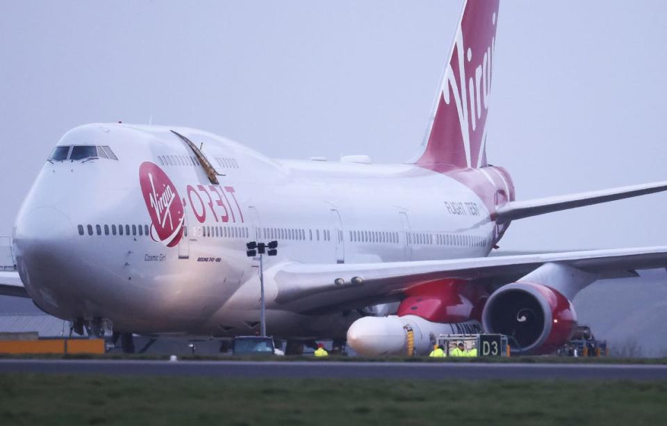 <div class="inline-image__caption"><p>Cosmic Girl, a Virgin Boeing 747, sits on the tarmac with Virgin Orbit's LauncherOne rocket attached to the wing at Spaceport Cornwall in Newquay, Britain, Jan. 9, 2023.</p></div> <div class="inline-image__credit">Henry Nicholls/Reuters</div>