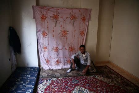 An internally displaced man rests inside a room he is currently living in, inside the rebel-held besieged eastern Ghouta of Damascus, Syria. REUTERS/Bassam Khabieh