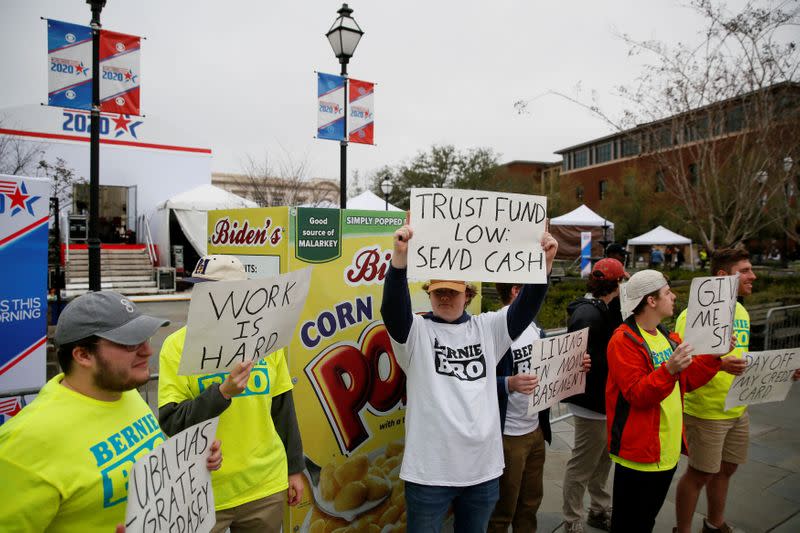 Satirists pretend to be supporters of Bernie Sanders outside the tenth Democratic 2020 presidential debate at the Gaillard Center in Charleston