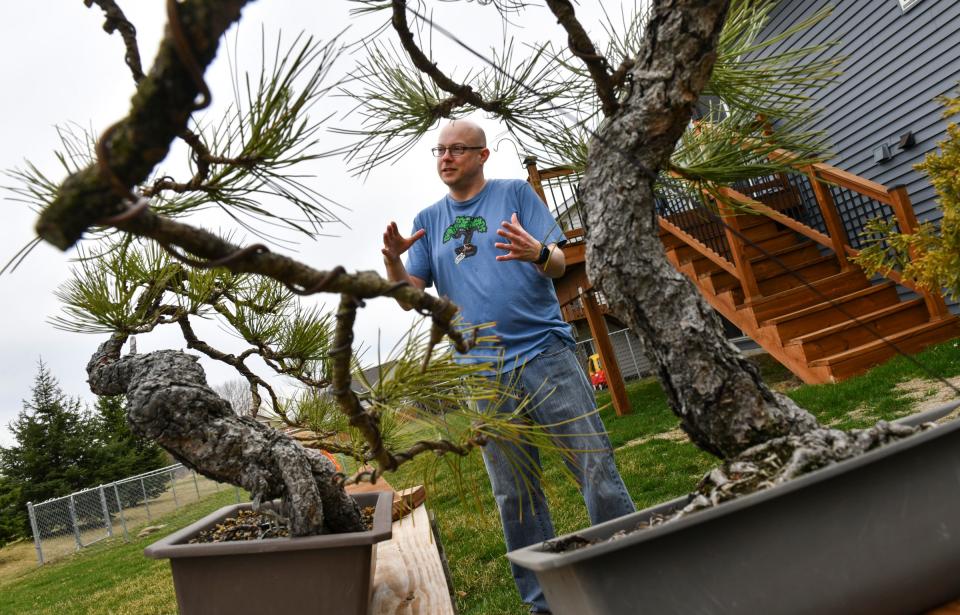Sumo Bonsai Supply owner Jeramiah Pearce talks about his business near trees growing at his home Friday, April 29, 2022, in Sartell.