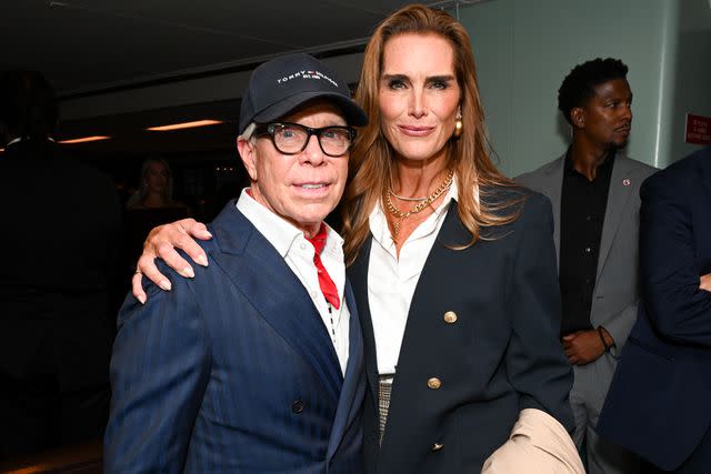 <p>Gilbert Flores/WWD via Getty</p> Tommy Hilfiger and Brooke Shields