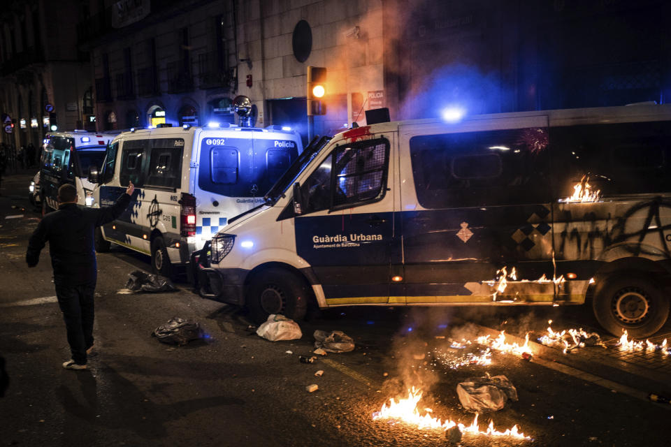 A police van burns after being attacked by demonstrators during a protest condemning the arrest of rap singer Pablo Hasél in Barcelona, Spain, Saturday, Feb. 27, 2021. After a few days of calm, protests have again turned violent in Barcelona as supporters for a jailed Spanish rapper went back to the streets. (AP Photo/Felipe Dana)