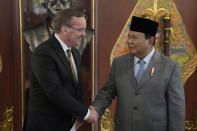 German Defense Minister Boris Pistorius, left, shakes hands with Indonesian Defense Minister Prabowo Subianto during their meeting in Jakarta, Indonesia, Monday, June 5, 2023. (AP Photo/Dita Alangkara)