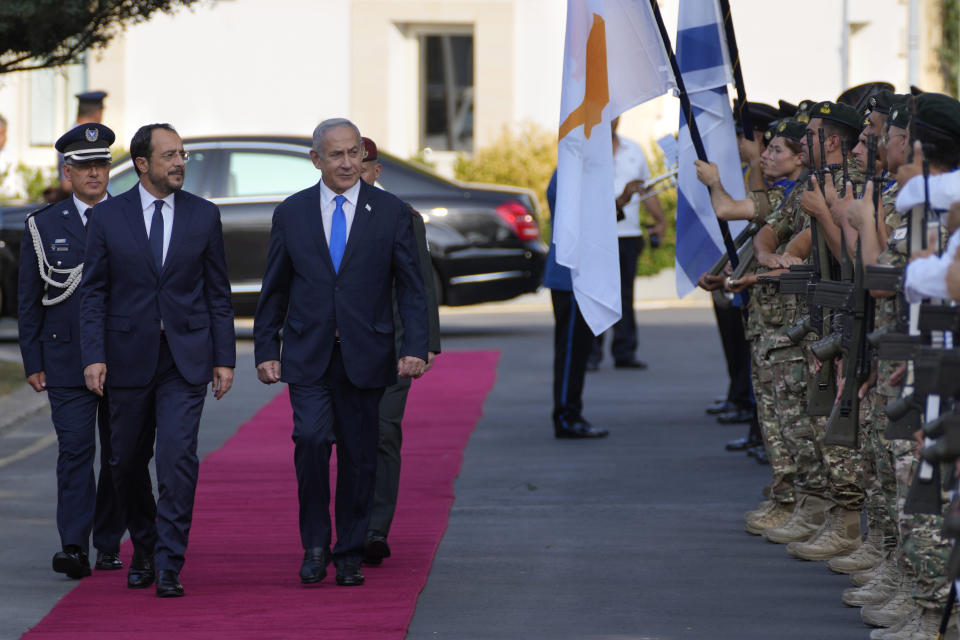 Cypriot President Nikos Christodoulides, left, and Israeli Prime Minister Benjamin Netanyahu review a military guard of honor before their meeting at the presidential palace in thecapital Nicosia, Cyprus, on Sunday, Sept. 3, 2023. An official statement said Christodoulides and Netanyahu will touch on expanding energy cooperation and bilateral ties, as well as Israel's relations with the European Union. The leaders' meeting comes a day ahead of a trilateral meeting that will include Greek Prime Minister Kyriakos Mitsotakis. (AP Photo/Petros Karadjias)