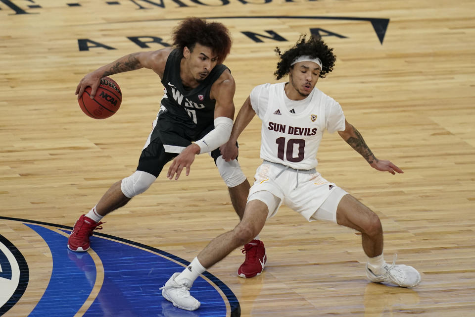Washington State's Isaac Bonton drives around Arizona State's Jaelen House during the second half of an NCAA college basketball game in the first round of the Pac-12 men's tournament Wednesday, March 10, 2021, in Las Vegas. (AP Photo/John Locher)