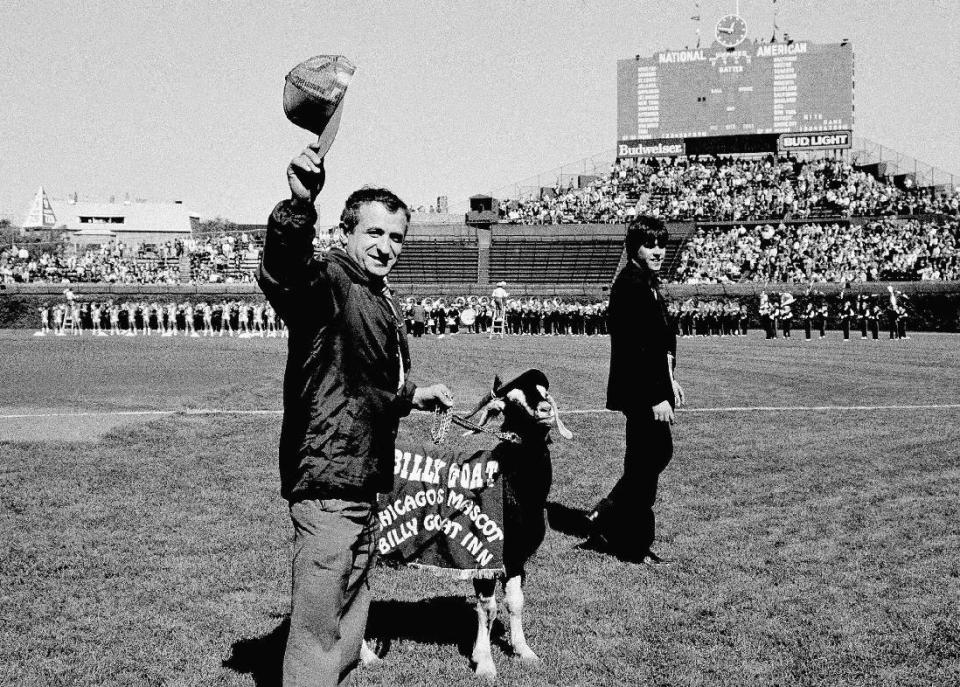 FILE - In this Oct. 2, 1984 file photo, Sam Sianis, owner of the Billy Goat Tavern in Chicago, acknowledges the crowd along with his goat prior to a National League baseball playoff game between the San Diego Padres and the Cubs in Chicago. From the goat that enjoyed a long, successful run cursing the Cubs to those who bet on Leicester to win the Premier League, it’s been a year to remember. (AP Photo/File)