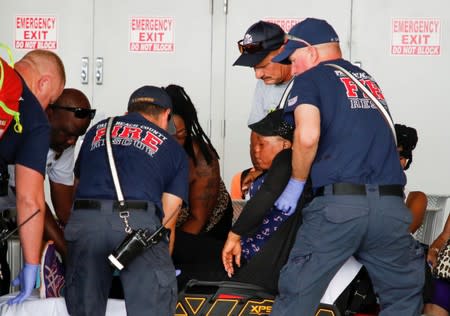 A passenger is transported by emergency workers after disembarking the Bahamas Paradise Cruise Line ship, Grand Celebration, in Riviera Beach