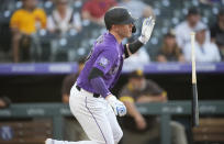 Colorado Rockies' Trevor Story follows the flight of his RBI-single off San Diego Padres starting pitcher Dinelson Lamet in the third inning of a baseball game Monday, June 14, 2021, in Denver. (AP Photo/David Zalubowski)