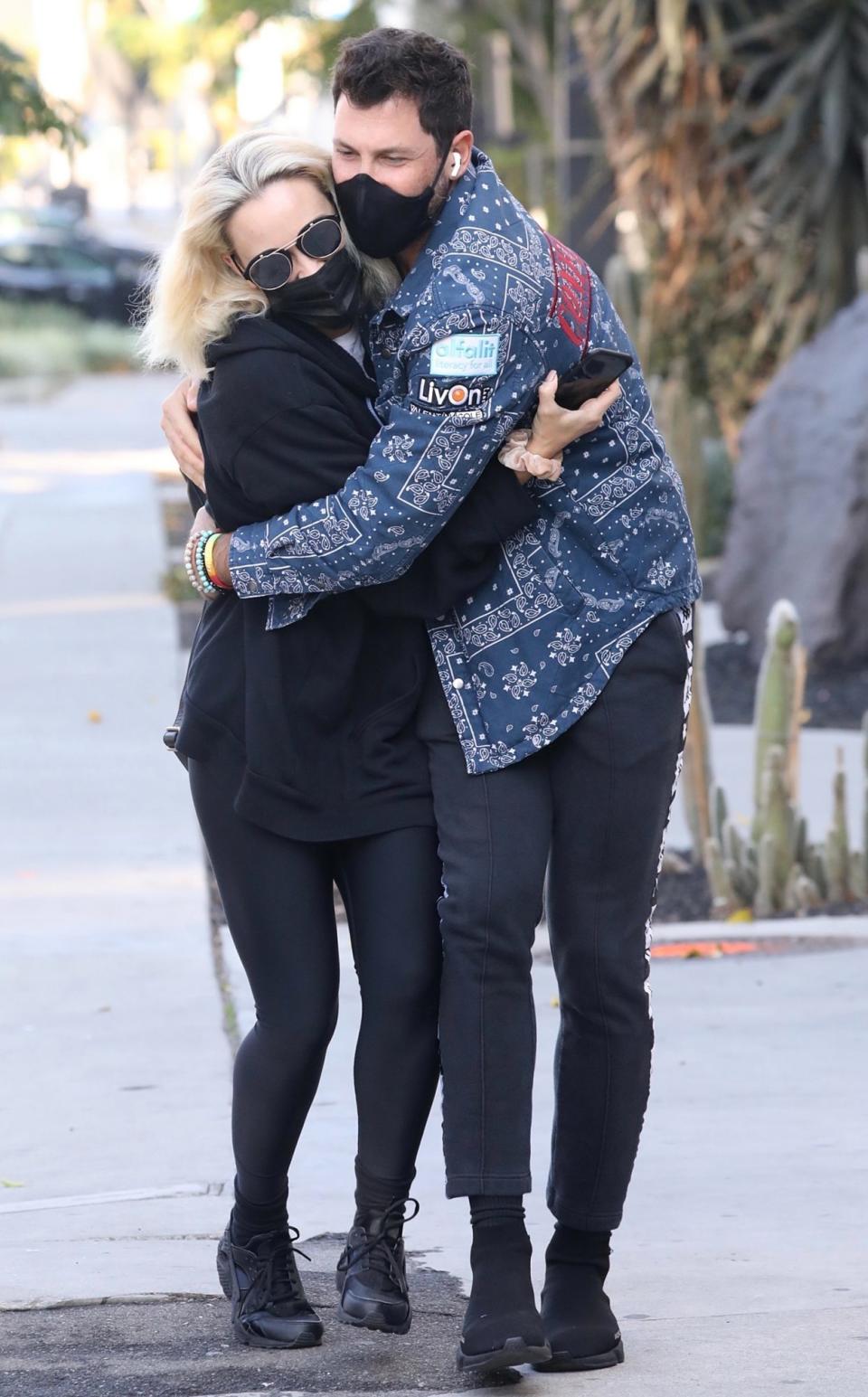 <p>Max Chmerkovskiy and wife Peta Murgatroyd cuddle up while walking to dinner at Zinque in West Hollywood on Wednesday. </p>