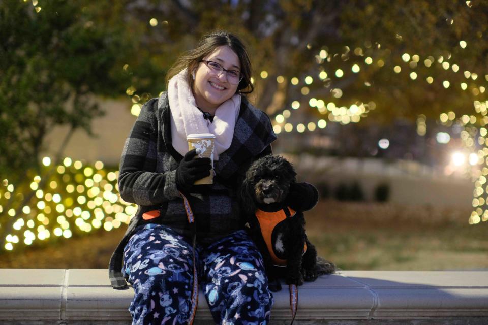 Leticia Parra and her dog Sasha enjoy some hot chocolate Thursday night at the WT lighting of the campus Christmas lights and winter carnival in Canyon.