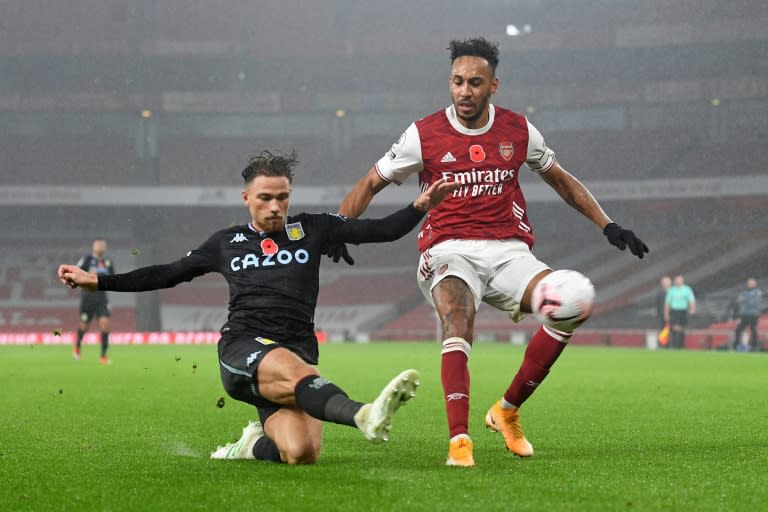 Arsenal forward Pierre-Emerick Aubameyang (R) is thwarted by Aston Villa defender Matty Cash during an English Premier League match in London Sunday.