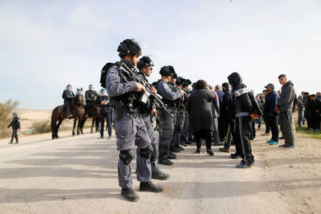 Israeli policemen stand guard following clashes in Umm Al-Hiran, a Bedouin village in Israel's southern Negev Desert January 18, 2017. REUTERS/Ammar Awad