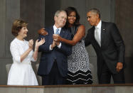 <p>First lady Michelle Obama, center, hugs former President George W. Bush, as President Barack Obama and former first lady Laura Bush walk on stage at the dedication ceremony of the Smithsonian Museum of African American History and Culture on the National Mall in Washington, Saturday, Sept. 24, 2016. (AP Photo/Pablo Martinez Monsivais)</p>