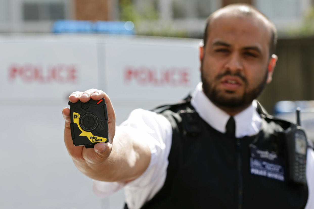 A police officer holds up a body camera used by the Met police: Yui Mok/WPA Pool/Getty Images