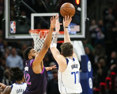 Jan 11, 2019; Minneapolis, MN, USA; Dallas Mavericks guard Luka Doncic (77) shoots over the Minnesota Timberwolves center Karl-Anthony Towns (32) during the fourth quarter at Target Center. Mandatory Credit: Brace Hemmelgarn-USA TODAY Sports