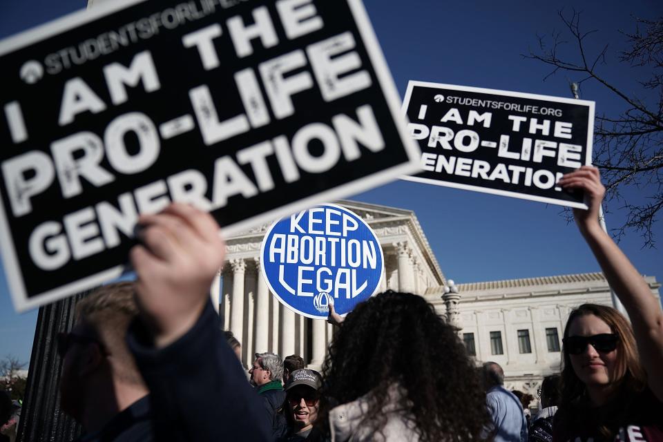 Pro-life activists try to block the sign of a pro-choice activist during the 2018 March for Life January 19, 2018 in Washington, DC.