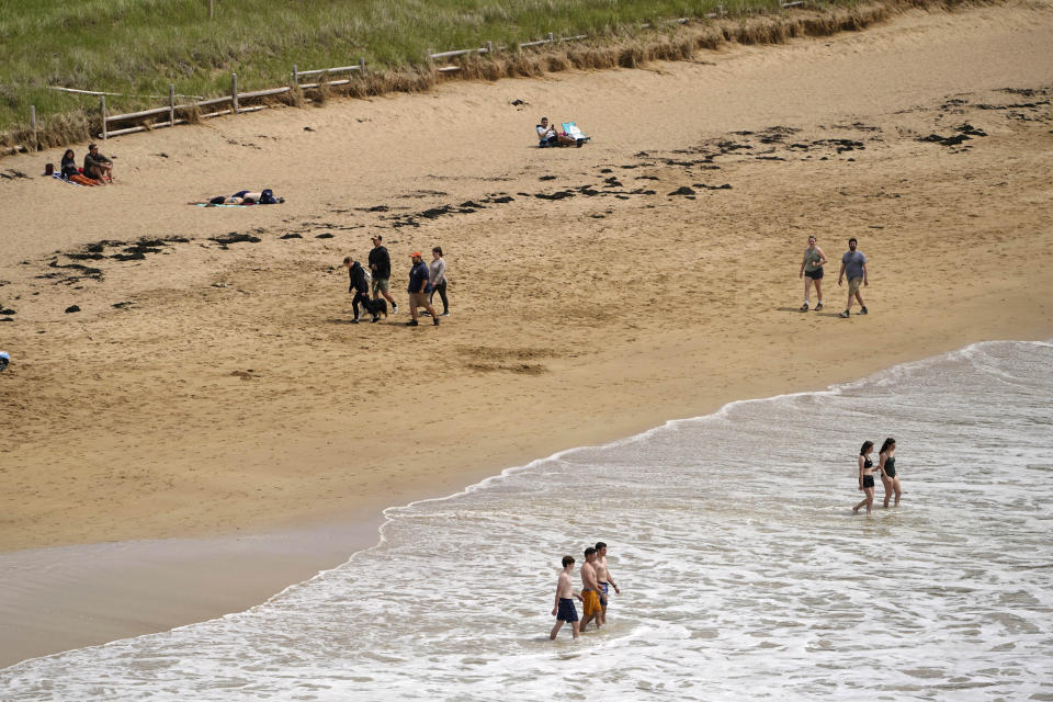 Brave swimmers wade into the chilly Atlantic Ocean at Sand Beach in Acadia National Park, Saturday, June 11, 2002, near Bar Harbor, Maine. The park will not have lifeguards on duty this summer due to worker and housing shortages. (AP Photo/Robert F. Bukaty)