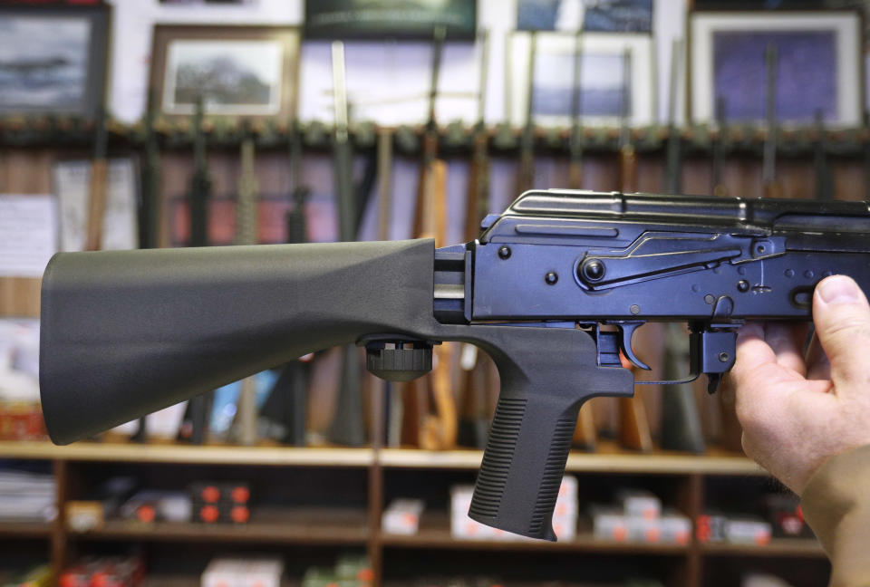 A bump stock device, which fits on a semi-automatic rifle to increase the firing speed, is installed on an AK-47 at a gun store. (Photo: George Frey/Getty Images)