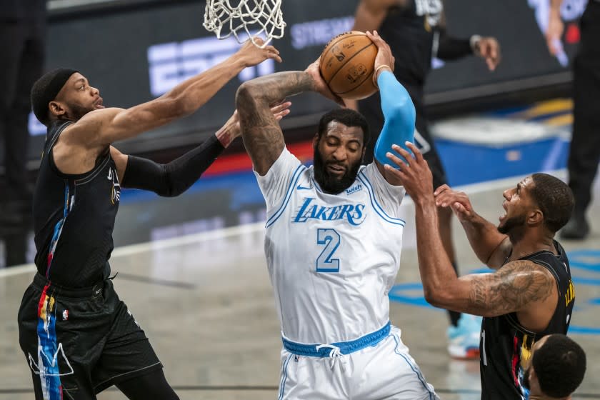 Los Angeles Lakers center Andre Drummond (2) grabs a rebound between Brooklyn Nets forward Bruce Brown.