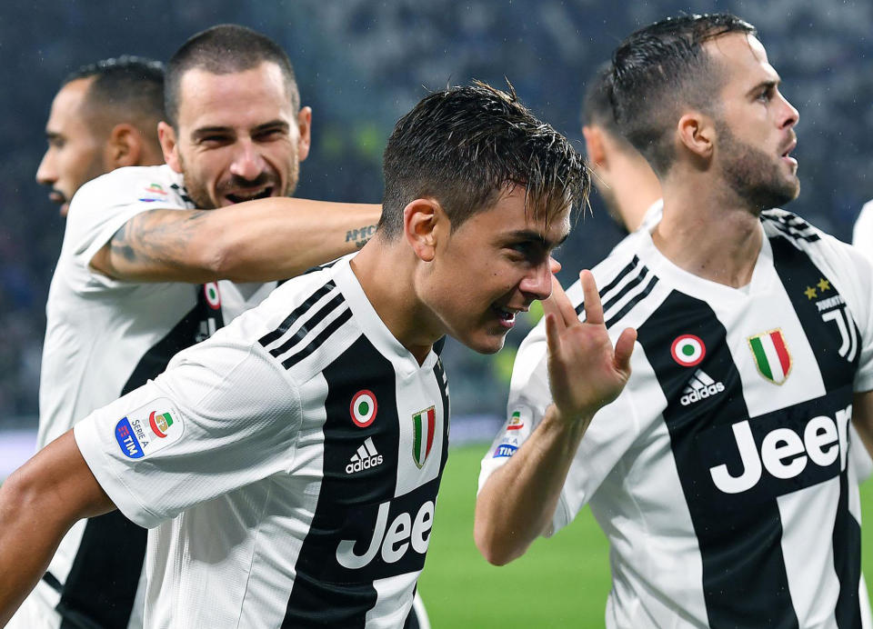 Juventus' Paulo Dybala, center, celebrates with his teammates after scoring his team's first goal during the Italian Serie A soccer match between Juventus and Cagliari at the Allianz Stadium in Turin, Italy, Saturday, Nov. 3, 2018. (Alessandro Di Marco/ANSA via AP)