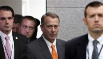 U.S. House Speaker John Boehner (R-OH) (C) arrives with his security detail for a House Republican caucus meeting at the U.S. Capitol in Washington, October 16, 2013. REUTERS/Jonathan Ernst