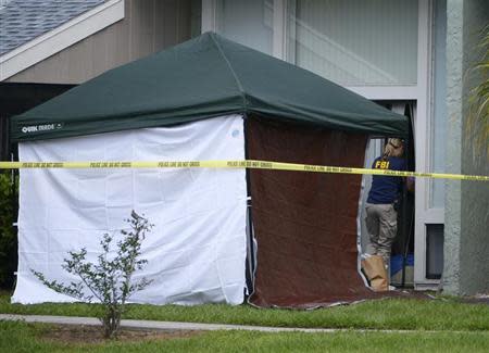 A member of the FBI enters the apartment of Ibragim Todashev, 27, in Orlando, Florida, May 22, 2013 file photo. REUTERS/Phelan M. Ebenhack