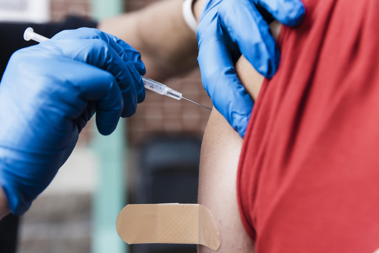A health care worker administers a dose of the Pfizer-BioNTech Covid-19 vaccine at a pop up vaccination site at Hammons Field in Springfield, Mo., on Aug. 3, 2021. (Angus Mordant / Bloomberg via Getty Images file)