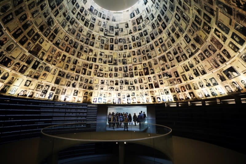 FILE PHOTO: Visitors enter the Hall of Names to look at pictures of Jews killed in the Holocaust during a visit to the Holocaust History Museum at the Yad Vashem World Holocaust Remembrance Center in Jerusalem