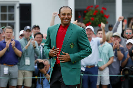 Golf - Masters - Augusta National Golf Club - Augusta, Georgia, U.S. - April 14, 2019 - Tiger Woods of the U.S. wears the green jacket as he celebrates after winning the 2019 Masters. REUTERS/Brian Snyder