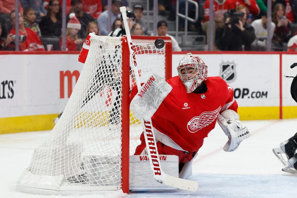 The puck hits the post behind Red Wings goaltender Alex Lyon in the first period against the Coyotes on Thursday, March 14, 2024, at Little Caesars Arena.