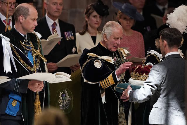 <p>ANDREW MILLIGAN/POOL/AFP via Getty Images</p> Prince William and King Charles look at the crown of King James V of Scotland during the National Service of Thanksgiving and Dedication.