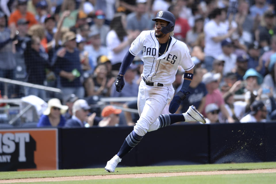 San Diego Padres' Fernando Tatis Jr. rounds third base on a RBI double hit by Francisco Mejia during the fifth inning of a baseball game against the Arizona Diamondbacks Wednesday, April 3, 2019, in San Diego. (AP Photo/Orlando Ramirez)