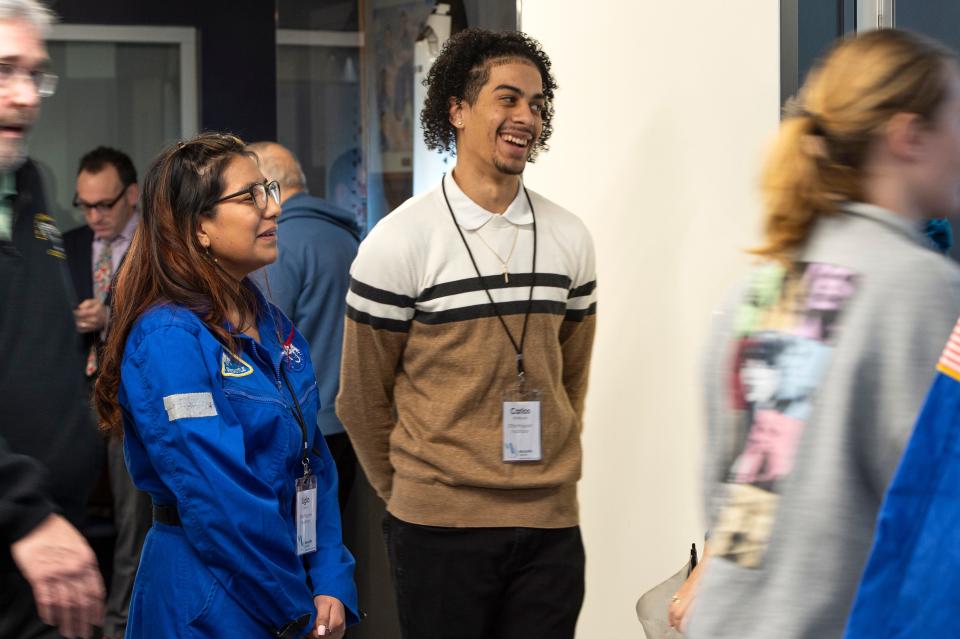 Ligia Puma and Carlos Rodriguez, STEM Program facilitators, greet arriving guests at the grand reopening of the Christa McAuliffe Center for Integrated Science Learning at Framingham State University, Jan. 26, 2024.