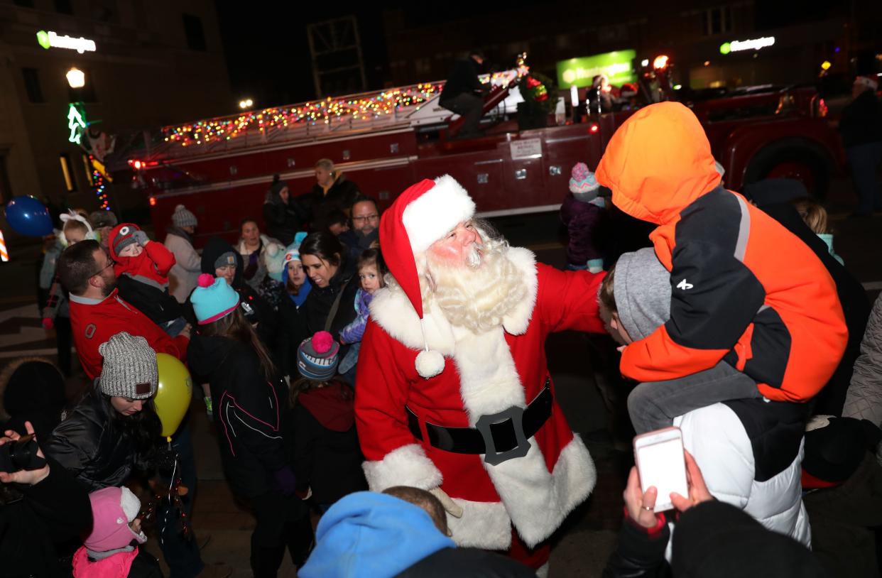 Santa greets a young admirer during a past Miracle on Main Street in Zanesville. This year, the Storybook Christms Parade will bring Santa to town Wednesday evening, starting at Secrest Auditorium at 6:30pm.