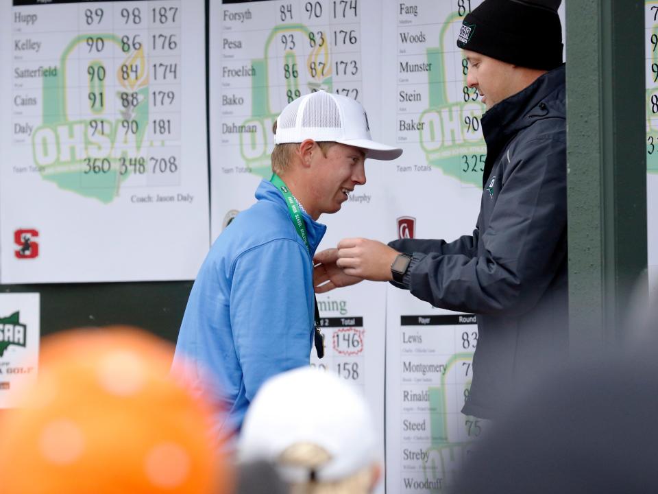 Wyoming senior Finley Barlett receives his championship medal after winning the Division II individual state championship on Saturday, Oct. 14, 2023, at NorthStar Golf Club in Sunbury, Ohio. Bartlett, who had the top qualifying district score among all 72 players, posted a two-day total of 146 to win by two shots. The Cowboys finished runner-up behind champion Kettering Alter.