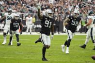 Las Vegas Raiders defensive end Yannick Ngakoue (91) celebrates after blocking a pass attempt against the Philadelphia Eagles during the first half of an NFL football game, Sunday, Oct. 24, 2021, in Las Vegas. (AP Photo/Rick Scuteri)