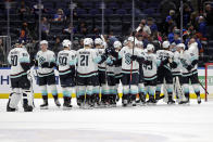 The Seattle Kraken celebrate after defeating the New York Islanders in an NHL hockey game Wednesday, Feb. 2, 2022, in Elmont, N.Y. The Kraken won 3-0. (AP Photo/Adam Hunger)