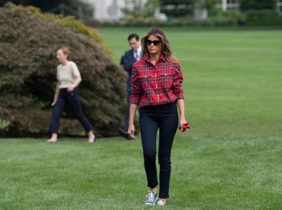 <p>FLOTUS wore a fall-inspired outfit to host her first White House Kitchen Garden event. She opted for a simple plaid shirt, dark blue skinny jeans, and Converse sneakers. </p>