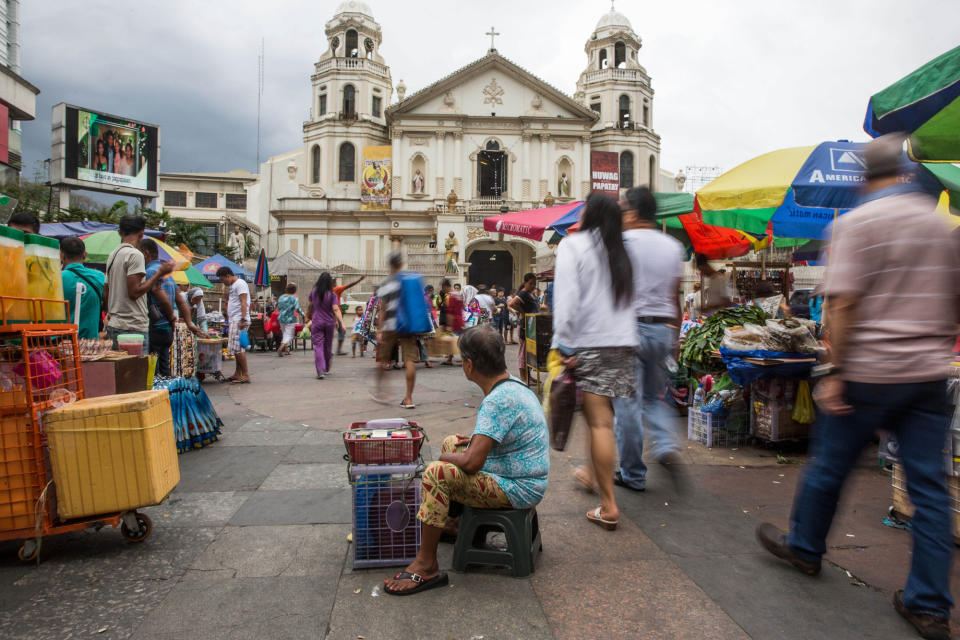 A vendor selling cigarettes waits for customers near a church at Quiapo Market in Manila. (Photo: Getty Images)