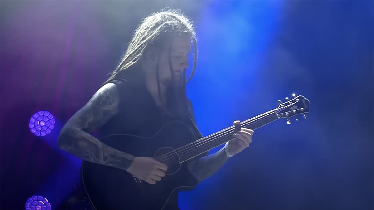  Bernth playing acoustic guitar on stage 
